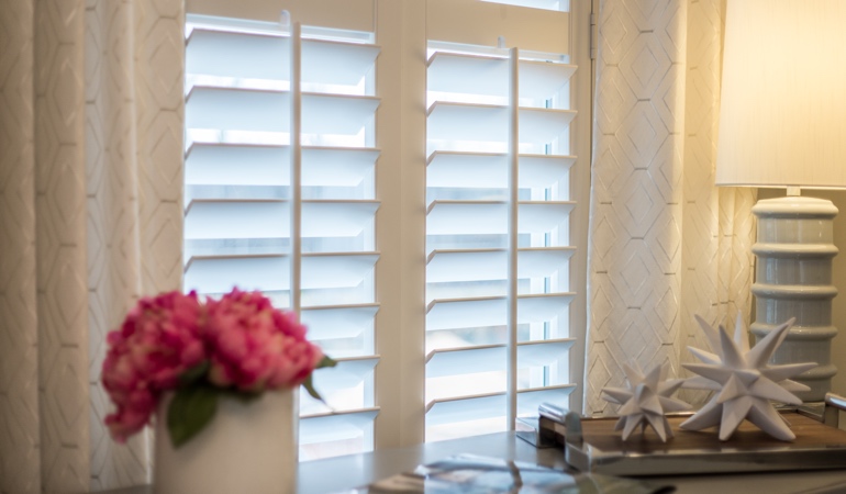 Plantation shutters by flowers in Miami